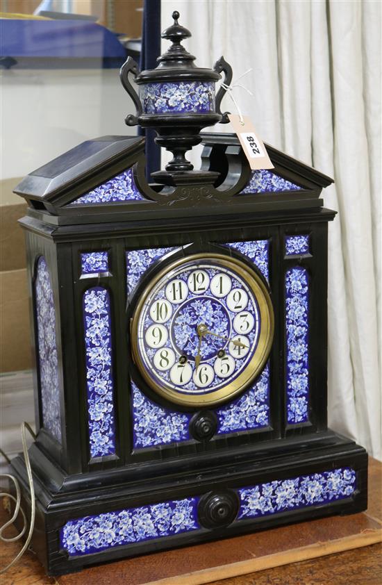 A Victorian aesthetic movement ebonised, blue and white ceramic mounted 8-day mantel clock